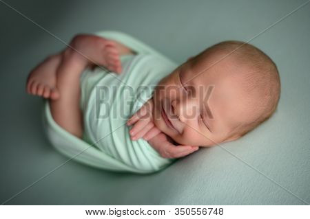 Newborn Baby Boy Sleeping Confort Pose On A Beanbag