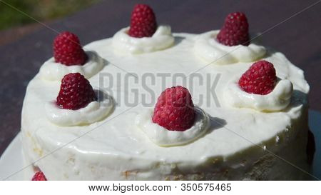 White Cake With Raspberries Sprinkled With Powdered Sugar.macro.