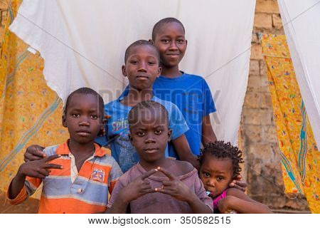 Bissau, Guinea-Bissau - January 5, 2020: group of African Kids looking at the camera in rural Guinea-Bissau