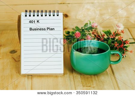 401 K Plan List With  Coffee Cup On Wood Table.