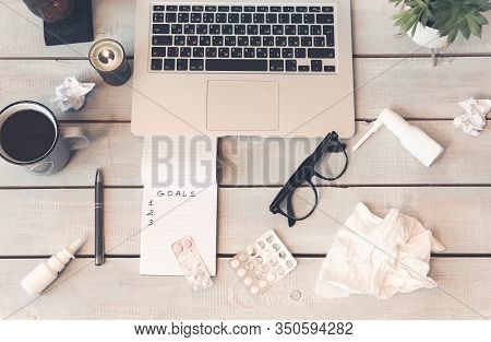 From Above Of Tissues And Medications With Cup Of Drink And Decorations On Wooden Background With La