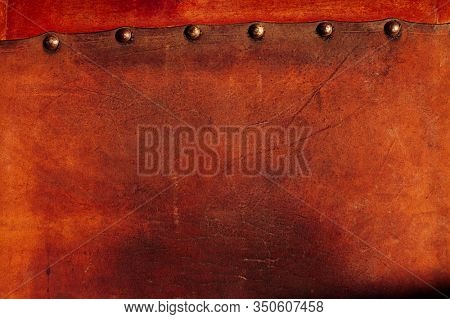 old  weathered leather tacked on wood background