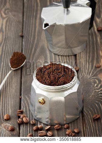 Roasted Coffee Beans In A Glass Jar, Scattered On A Wooden Brown Table. Hand Mill And Coffee Pot (la