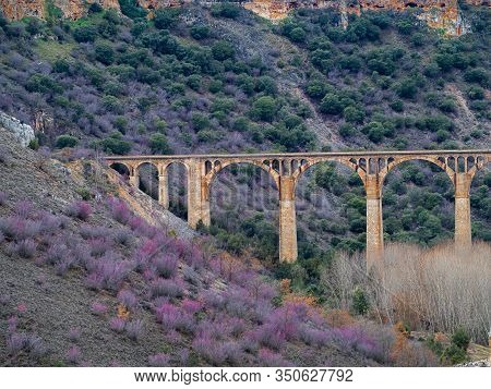 Isolated Stone Aquaduct In The Middle Of A Forest With Large Rocks In Maderuelo In Spain
