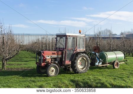 Sint Gillis Waas, Belgium January 16 2020 Tractor With Dung Cart In The Background The Buildings Of 