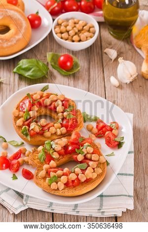 Friselle With Tomatoes And Chickpeas On White Dish.
