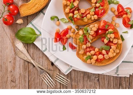 Friselle With Tomatoes And Chickpeas On White Dish.