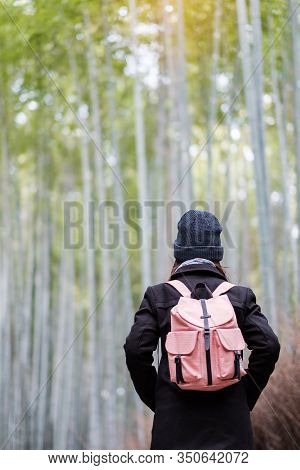 Young Woman Traveling At Arashiyama Bamboo Grove, Happy Asian Traveler Looking Sagano Bamboo Forest.
