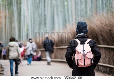 Young Woman Traveling At Arashiyama Bamboo Grove, Happy Asian Traveler Looking Sagano Bamboo Forest.