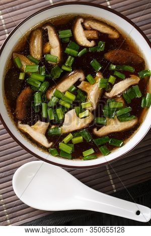 Portion Of Japanese Soup With Shiitake Mushrooms And Green Onions Close-up In A Bowl. Vertical Top V