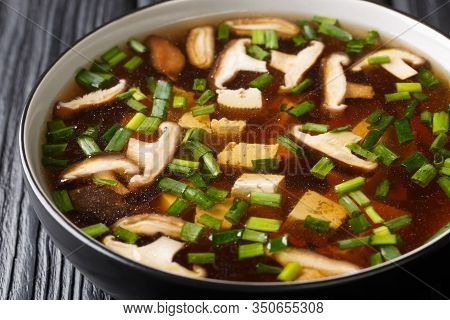 Asian Soup With Shiitake Mushrooms, Tofu Cheese And Green Onions Close-up In A Bowl. Horizontal