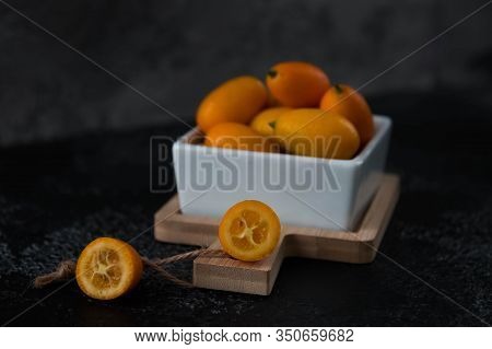 Cut Fruit Kumquat On A Black Background