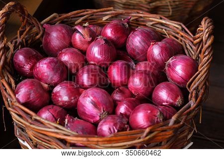 Red Onions In A Wooden Basket. The Spring Avitaminosis.selective Focus. Close Up