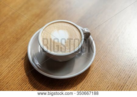 Coffee Cup Fresh Cream Organic Cappuccino On Table In Cafe. Latte Macchiato Drink In Glass Close Up.