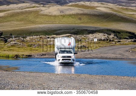Eldgja Iceland - July 6. 2020: Toyota Hilux Pickup Truck With A Camper Crossing A River