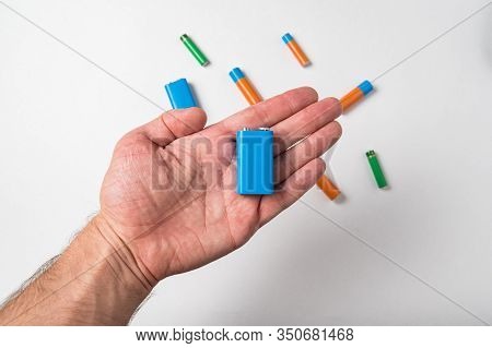 Blue Pp3 Battery In Male Hand On White Background. Different Types Of Accumulatores