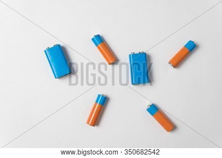 Aa And Pp3 Batteries On White Background. Different Types Of Accumulatores. Top View.
