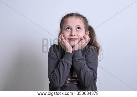 Portrait Of A Little White Girl Moony,dreamy On A Gray Background