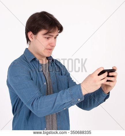 Angry Man Plays Mobile Game On His Smartphone.