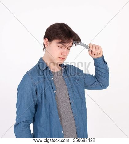 Portrait Of Young Man While Holding Wrench On White Background.
