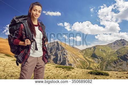 Female hiker with a backpack climbing a mountain in Macedonia