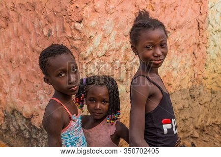 Bissau, Guinea-Bissau - January 5, 2020: group of African Kids looking at the camera in rural Guinea-Bissau