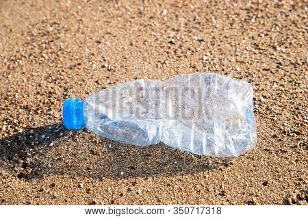 Plastic Pollution In Sea. Plastic Bottle On Sea Shore