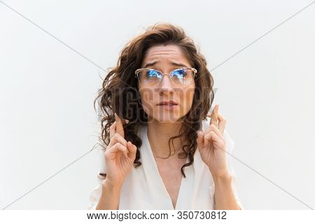 Disquieting Young Woman Showing Cross Fingers Gesture. Attractive Lady Wanted To Make Her Wishes Com