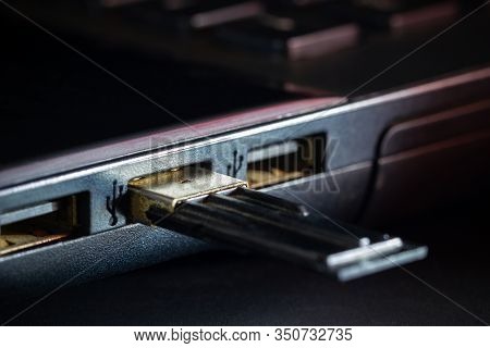 Flash Drive In Usb Port Of Computer Notebook In Darkness. Concept Of Technological Advances In Compu