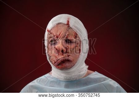 Crazy Zombie Horror Make Up. Person In Blue Madical Shirt And Bandaged Head. Scars, Deep Scratches R