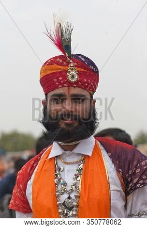 BIKANER, INDIA - JANUARY 12, 2020: Rajasthani handsome men in traditional clothes with beard and lon