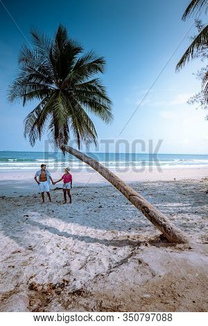 Wua Laen Beach Chumphon Area Thailand, Palm Tree Hanging Over The Beach With Couple On Vacation In T