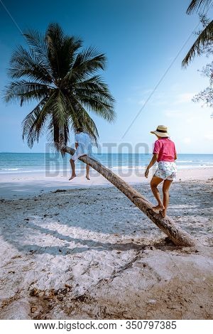 Wua Laen Beach Chumphon Area Thailand, Palm Tree Hanging Over The Beach With Couple On Vacation In T