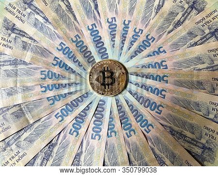 A Golden Bitcoin On Vietnamese Billnotes