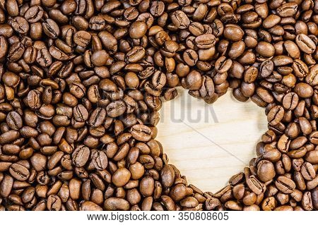 Roasted Brown Coffee Beans With Empty Heart Form Shape.
