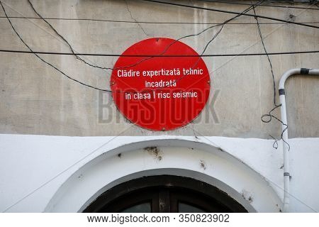 Bucharest, Romania - February 12, 2020: Warning Sign On An Old Building Reading In Romanian  That Th
