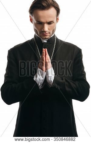 Serious Catholic Priest Praying With Bowed Head Isolated On White