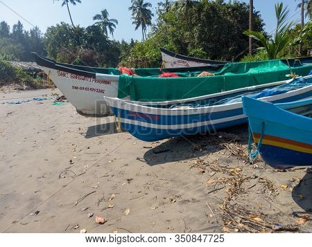 Morjim, India December 14, 2019: Empty Boat On Sandy Beach In Bright Day. Large Old White Boat On Sa