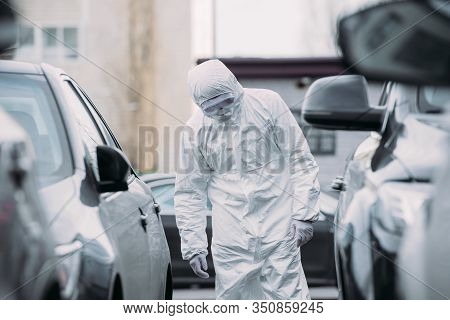Selective Focus Of Asian Epidemiologist In Hazmat Suit And Respirator Mask Inspecting Vehicles On Pa