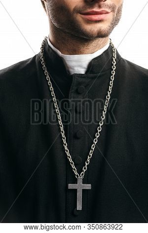 Partial View Of Catholic Priest In Black Cassock, With Silver Cross On Necklace, Isolated On White