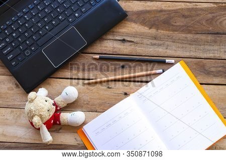 Notbook Monthly Planner With Computer For Business Work And Teddy Bear Of Lifestyle At Office Arrang