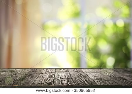 Wooden Table And Blurred View Through Window On Garden In Morning. Springtime