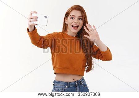 Friendly Attractive Redhead Modern Woman Contact Friend Abroad Using Internet, Holding Smartphone Ho