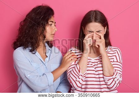 Close Up Portrait Of One Teenage Girl Comforting Another After Break Up, Female Wearing Striped Shir