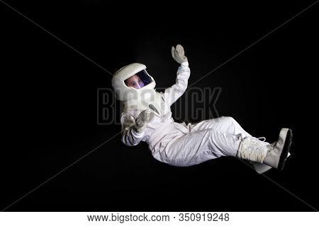 Astronaut In Space, In Zero Gravity On Black Background.