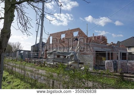 Sint Gillis Waas, Belgium, February 12, 2020. The Side Of A House Under Construction In Red Brick, A