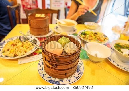 Chinese Restaurant At Yokohama Chinatown In Japan With Asian Steaming Dumplings In A Wooden Steamer,