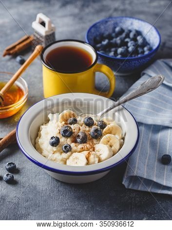Milk Rice Porridge With Blueberry, Banana, Honey And Cinnamon, Creamy Rice Pudding Or French Riz Au 