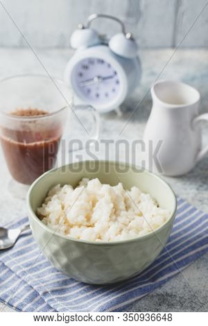 Breakfast With Milk Rice Porridge, Creamy Rice Pudding Or French Riz Au Lait In A Bowl, Glass Cup Wi