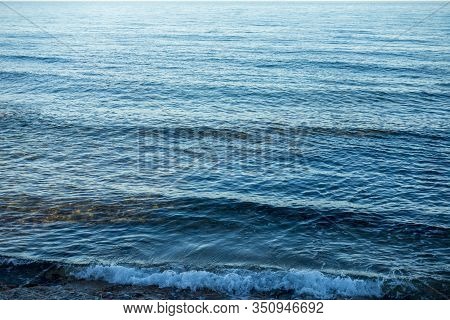 Calm Waves On The Shore Of The Blue Sea